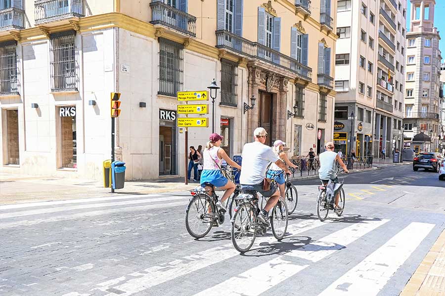 ridign-bikes-in-spain-streets-malaga