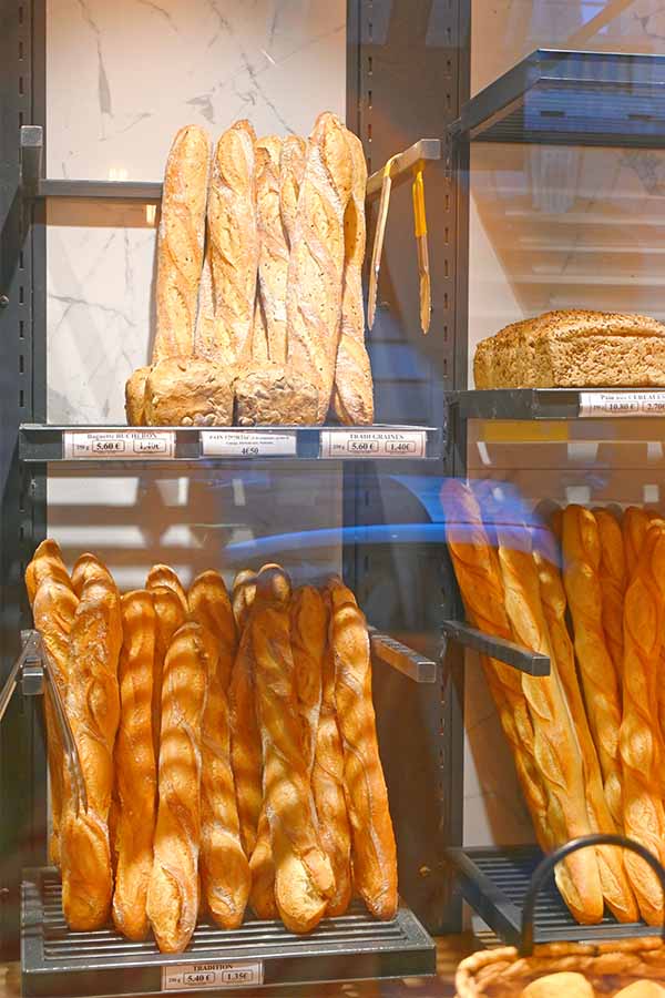 variety-of-freshly-baked-crusty-french-baguettes-and-artisan-loaves-arranged-on-shelves-in-a-paris-bakery