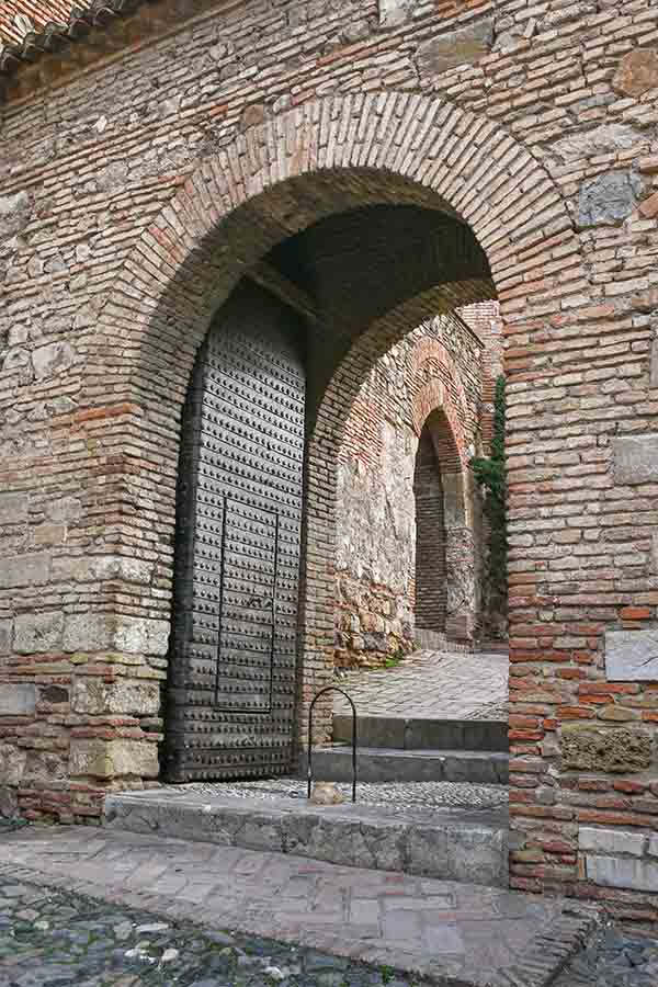 ancient-fortified-brick-archway-and-studded-heavy-door-ideal-for-historical-travel