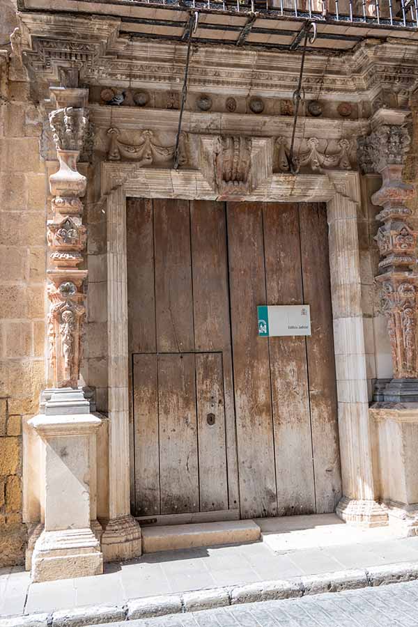 ancient-wooden-door-with-ornate-stone-carvings-showcasing-vintage-travel