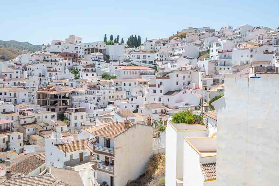 dense-hillside-view-stacked-white-houses-Almachar-Spain-white-villages-Andalusia