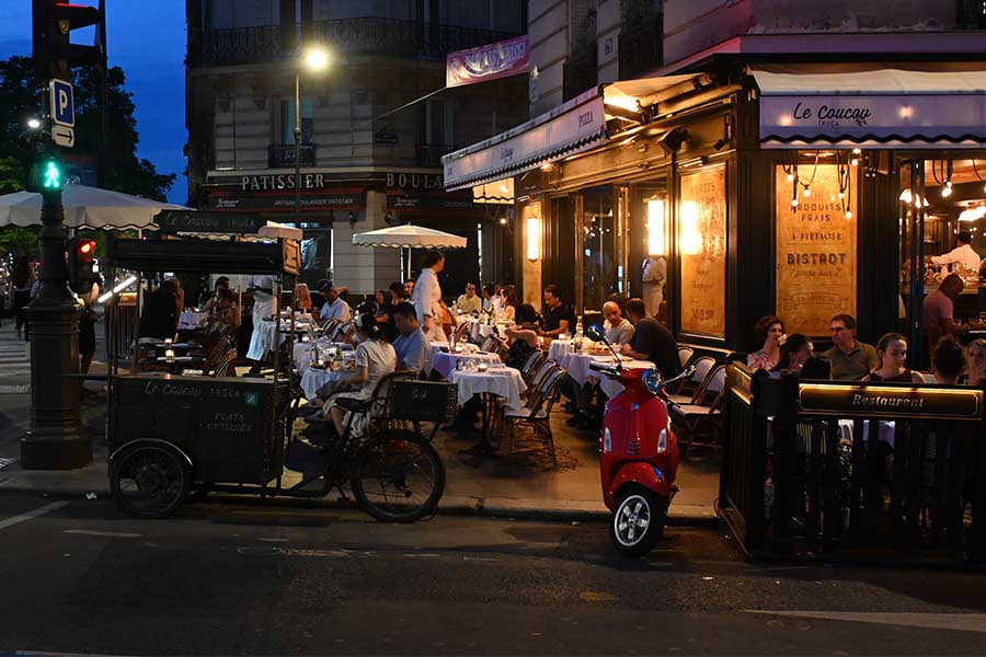 night-photography-a-lively-parisian-bistro-street-scene-with-a-red-scooter-parked-outside