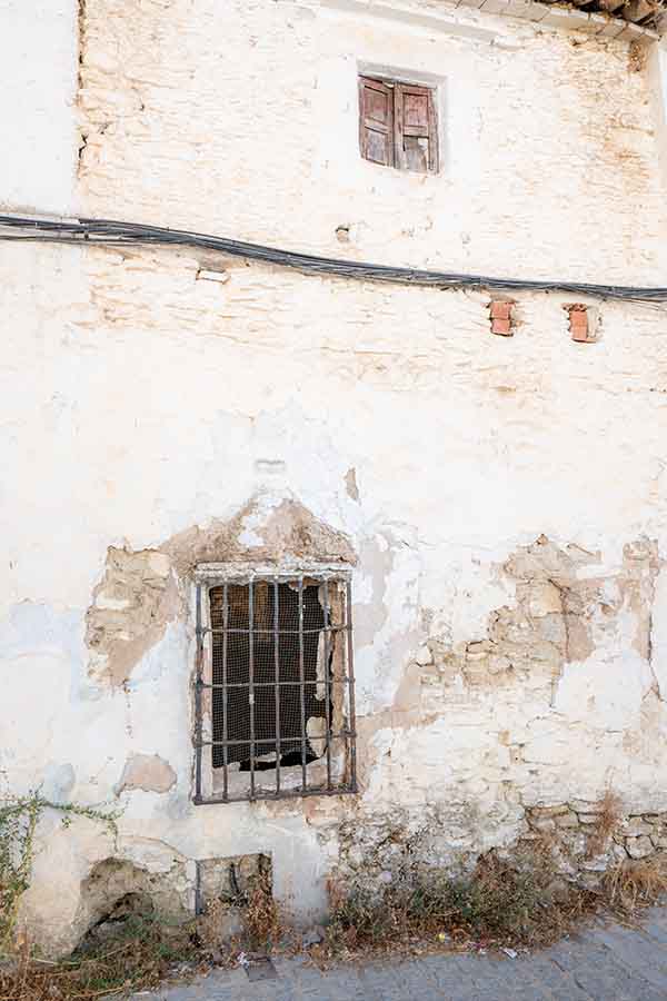 rustic-weathered-wall-and-barred-window-reflecting-vintage-travel