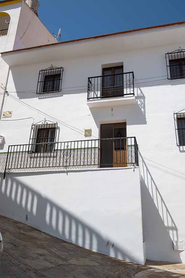 steep-sloped-street-white-house-black-balconies-Almachar-Spain-white-villages-Andalusia